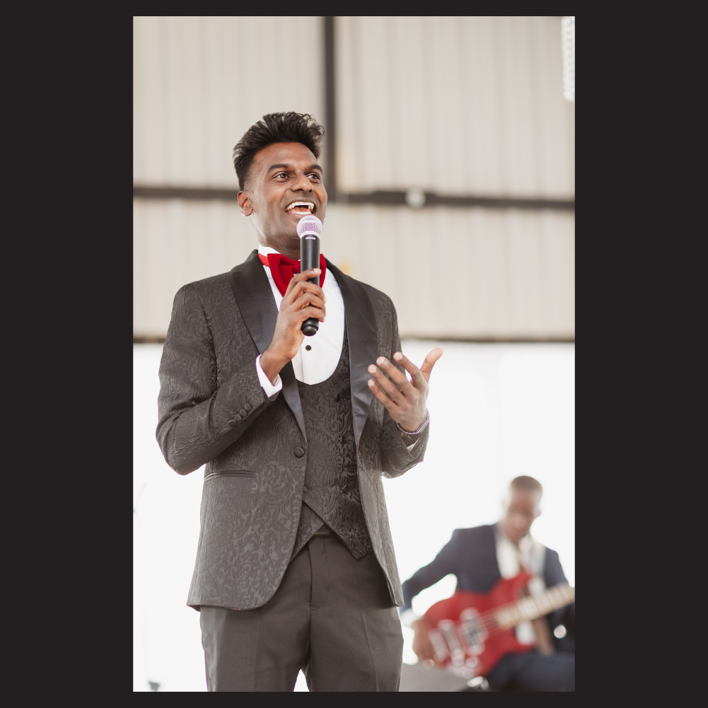 Wesley Chetty hosting a large event on stage
